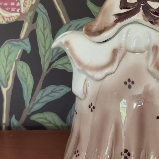 Front view of Tony Wood Little Old Lady teapot in brown Staffordshire pottery with hand painted facial features and patterned bonnet
