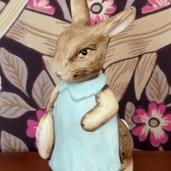 Vintage Beswick Mrs Flopsy Bunny figurine styled on a wooden shelf in front of William Morris Pimpernel wallpaper.