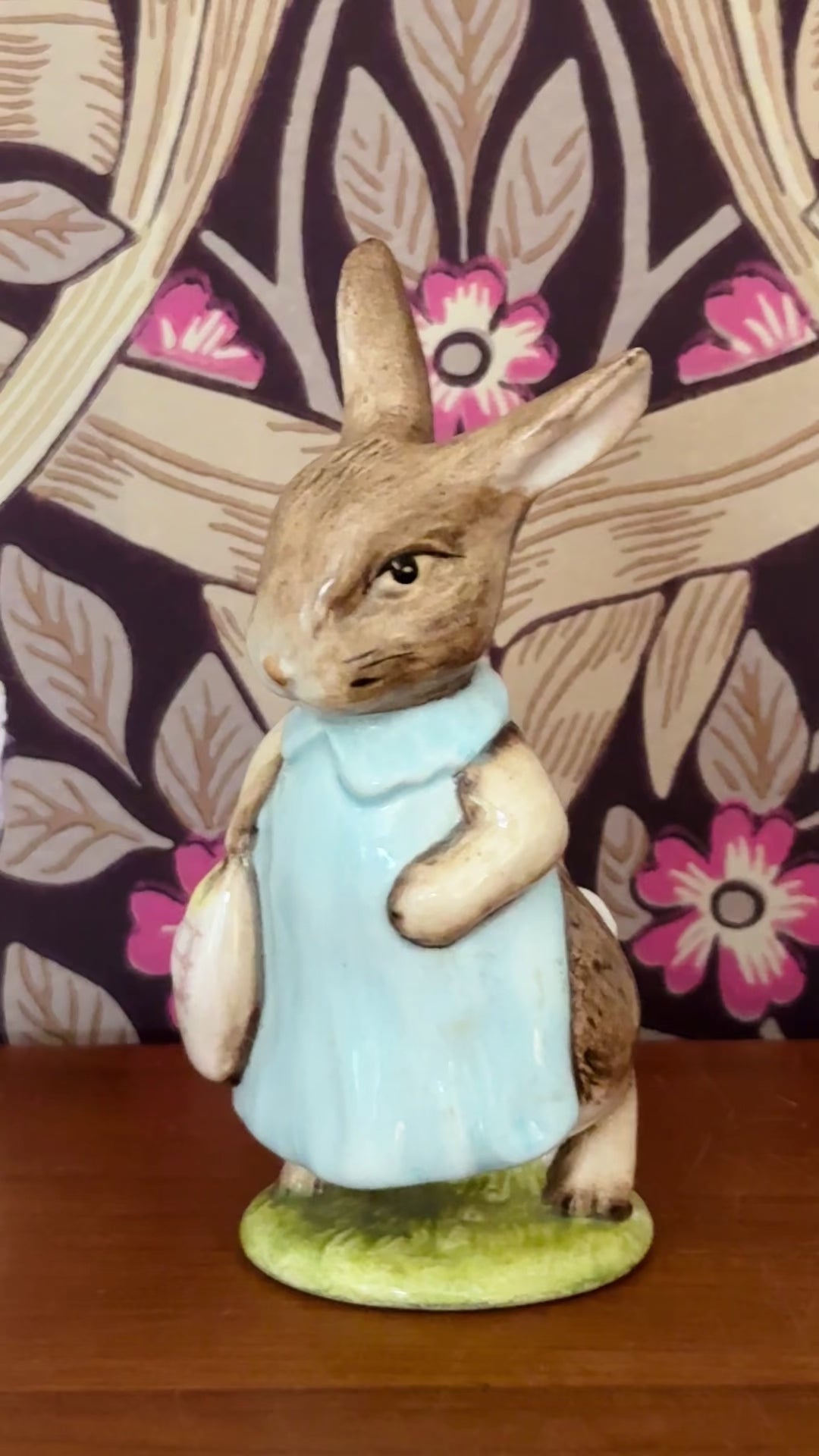 Vintage Beswick Mrs Flopsy Bunny figurine styled on a wooden shelf in front of William Morris Pimpernel wallpaper.