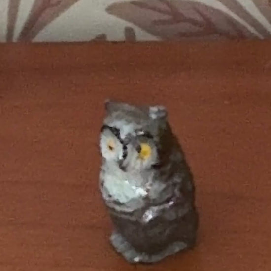 close up of grey and white hand painted lead collectable owl figurine