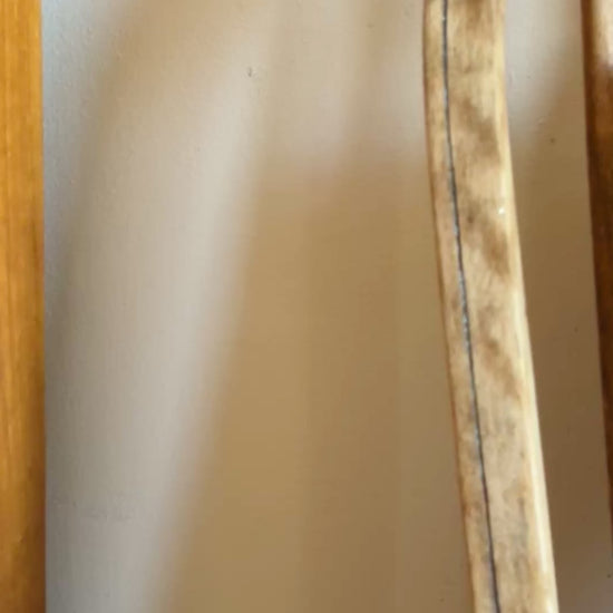 Greek Lunch framed embroidered wall art on antique wooden seat sunny summer display