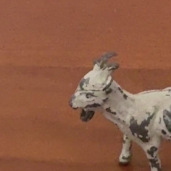 close up of white hand painted lead goat collectable