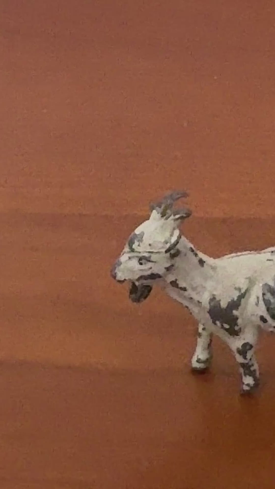 close up of white hand painted lead goat collectable