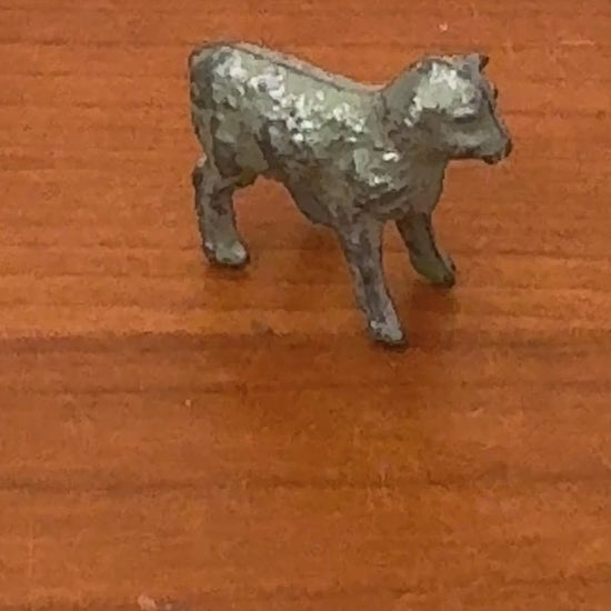 close up of antique lamb lead toy farm figurine