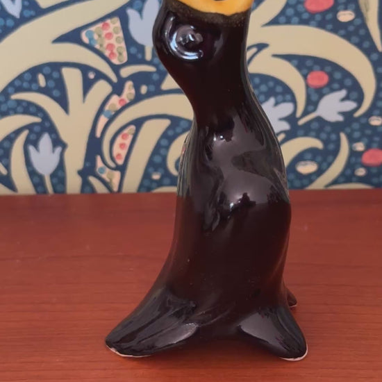Close up of vintage ceramic glazed black bird pie funnel