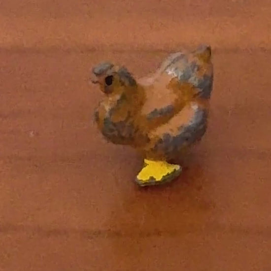 close up of miniature chicken lead figurine