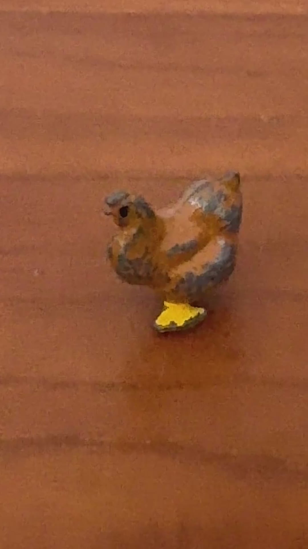 close up of miniature chicken lead figurine