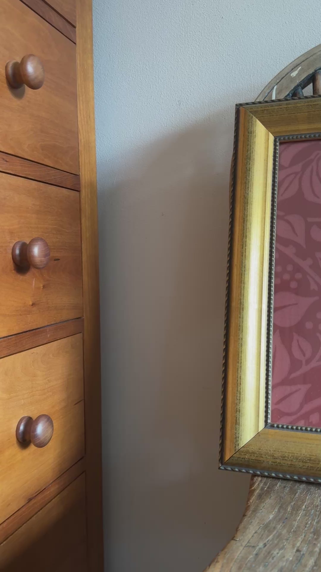 Anitque gold framed William Morris framed print placed on old wood chair seat.