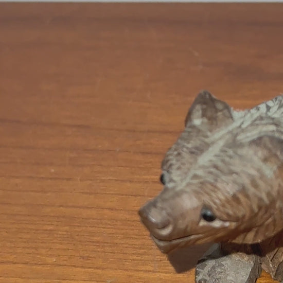 Vintage carved wooden bear with glass eyes close up detail