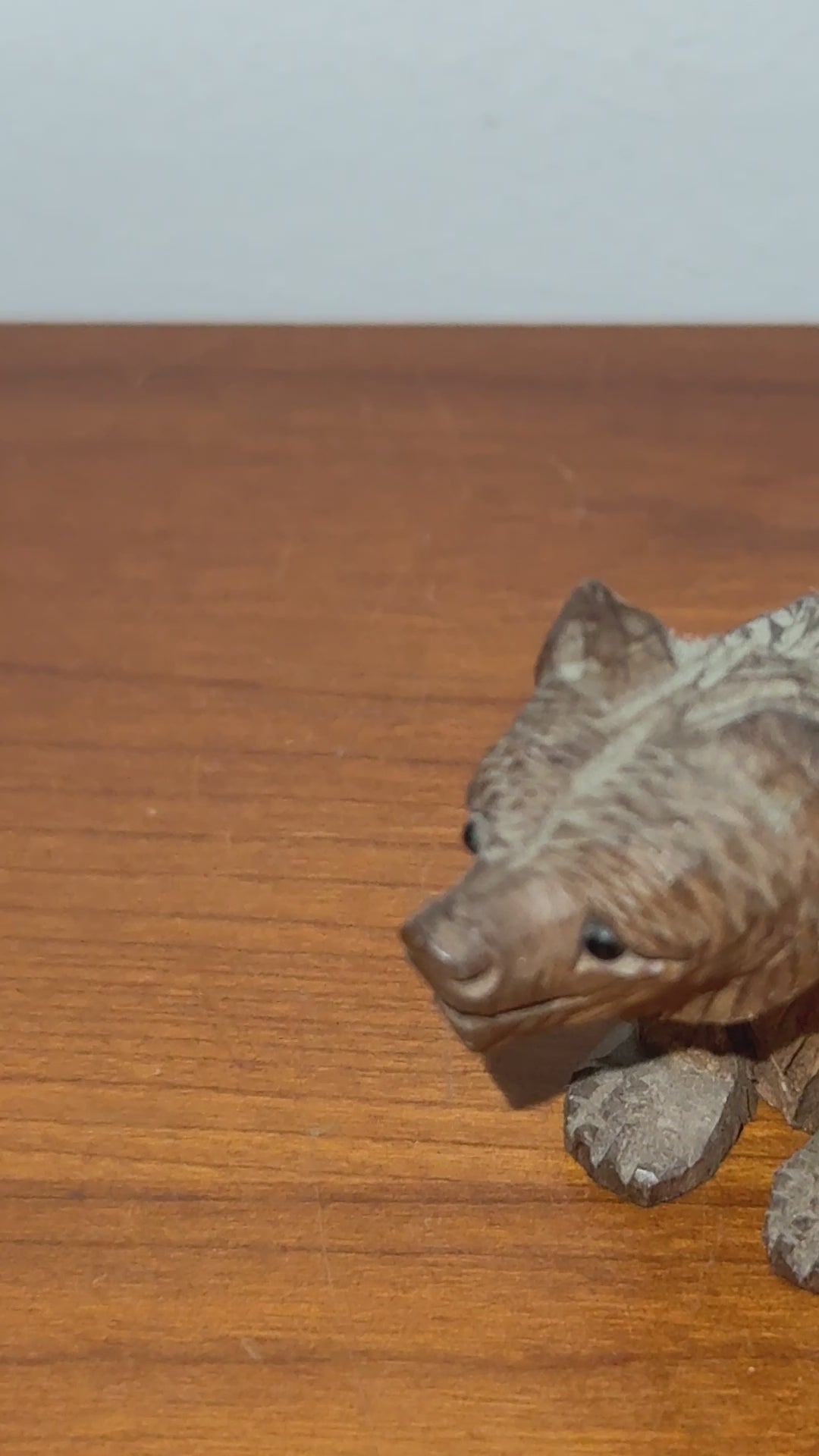 Vintage carved wooden bear with glass eyes close up detail