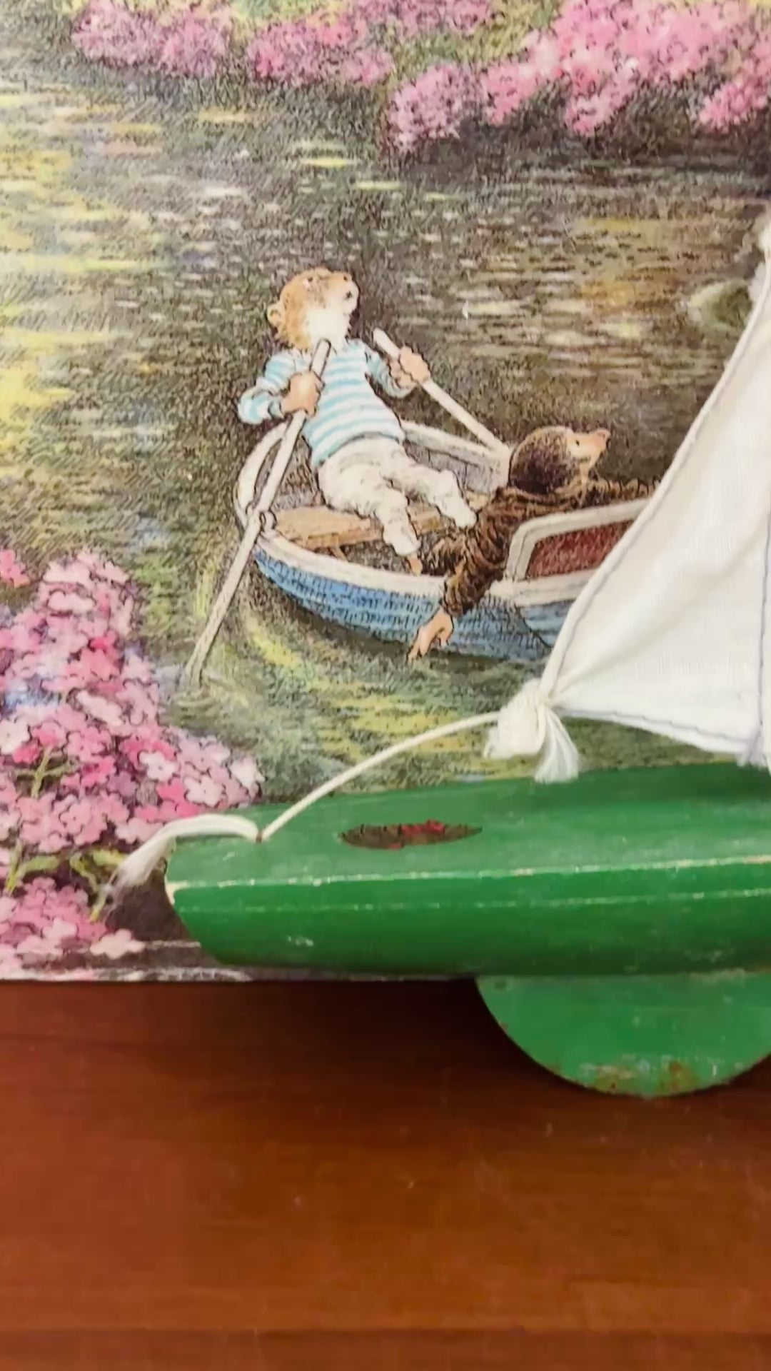 Small vintage Star Yachts green pond yacht with removable white sail and aged original wooden hull.
