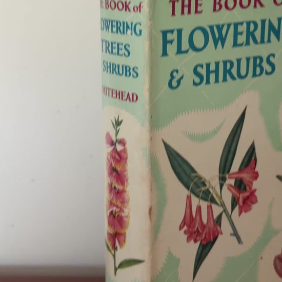Video showing 1956 Book of Flowering Trees and Shrubs vintage botanical hardback with floral dust jacket