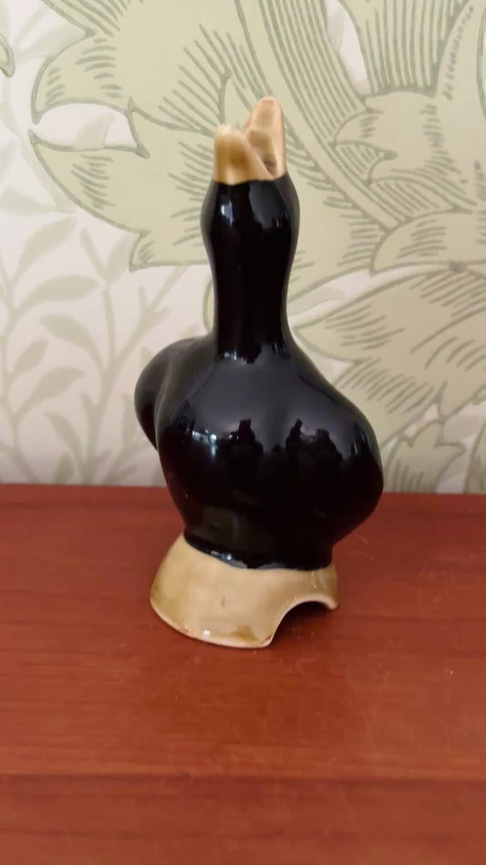 Vintage black ceramic pie bird on olive log base